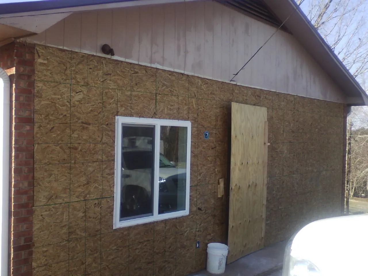 OSB sheathing on a garage addition wall before siding in Appling