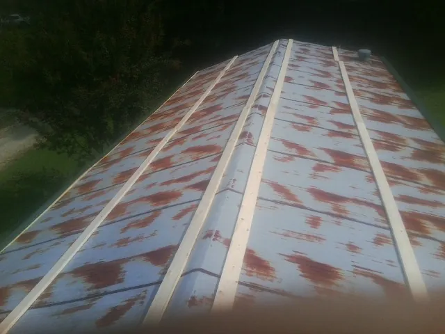 Rusted metal roof panels with new wood purlins before replacement — Storm Damage Roof Repair in Appling by Roofing Brothers